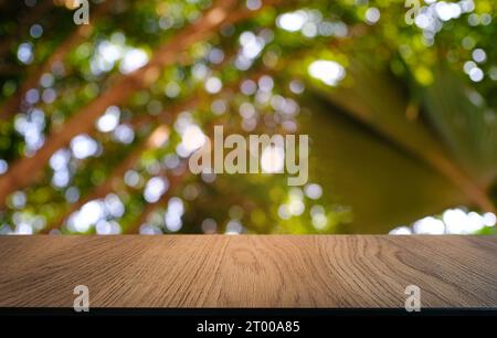 Empty dark wooden table in front of abstract blurred bokeh background of restaurant . can be used for display or montage your pr Stock Photo