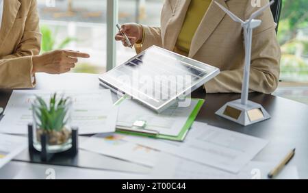 Solar panels green energy Business people working in green eco friendly office business meetingÂ creative ideas for business eco Stock Photo