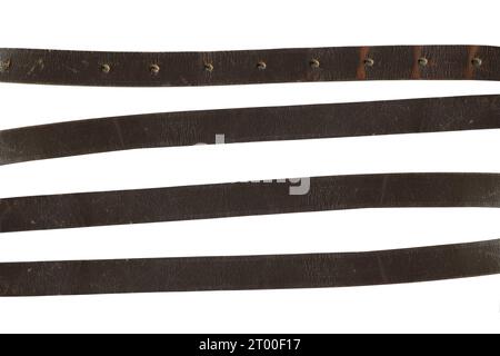 A set of worn leather strips on a white background. leather belt Stock Photo