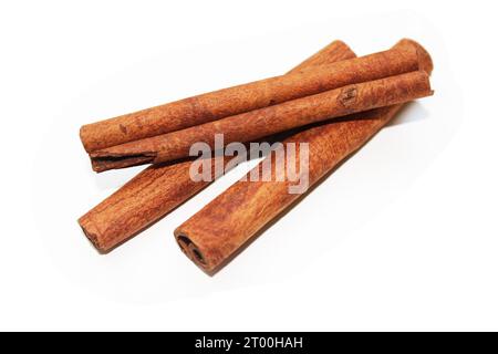 cookie baking or as advent season realistic christmas decoration on light background, Cinnamon spice - three wonderfully aromatic aromatic sticks Stock Photo