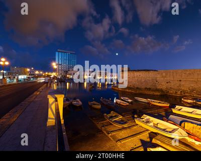 Night in Gallipoli, province of Lecce, Puglia, southern Italy.  People and signs unrecognizable. Stock Photo