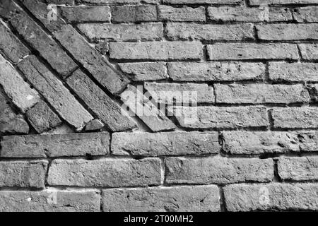 An old brick wall partly in black and white. Meant as background Stock Photo