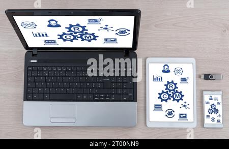 Crm concept shown on different information technology devices Stock Photo