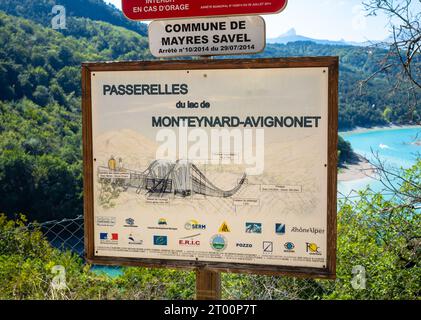 An technical information board explaining the engineering used and sponsorship for the suspension footbridges or Passerelles du lac de Montynard-Avign Stock Photo