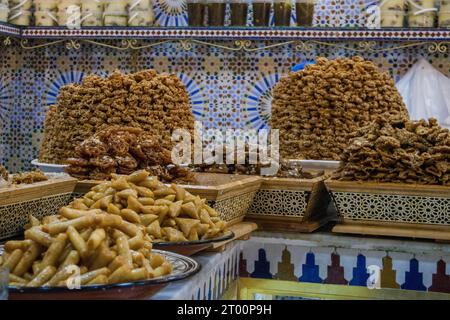 A plate full of delicious honey-glazed fried pastry sweet on display in a pastry shop in Morocco Stock Photo