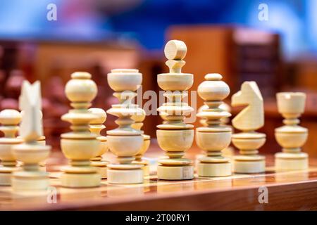 White wooden chess pieces photographed from side with colorful background Stock Photo
