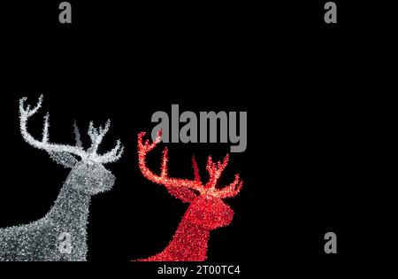 Silver  and Red Illuminated Christmas Reindeer Shaped Outdoor Decoration Lights on Night Sky Background Stock Photo
