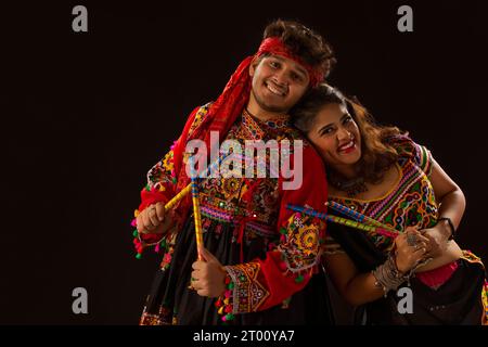 Couple performing Dandiya Raas at Navratri Stock Photo - Alamy