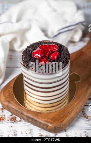 Raspberry cake. Delicious chocolate covered cake on a white background. Stock Photo