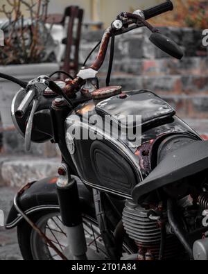 A vintage rusty motorbike on a street in Crete, Greece Stock Photo