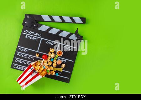 Horror movie, series night, Halloween cinema party with trick-or-treating sweets bucket, popcorn, movie clapperboard and Halloween decorations on high Stock Photo