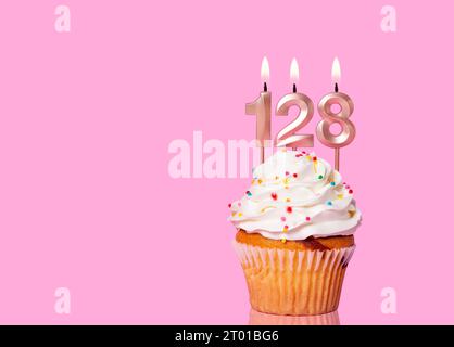 Birthday Cake With Candle Number 128 - On Pink Background. Stock Photo