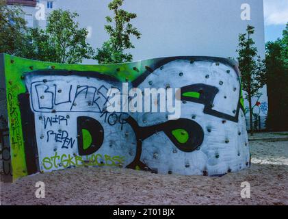 Huge Graffiti on a Naighbourhod, Playground Wall inside the Winsviertel Wuarter. Berlin, Germany. Image shot on Analog, Old Stock Kodak Film. Stock Photo