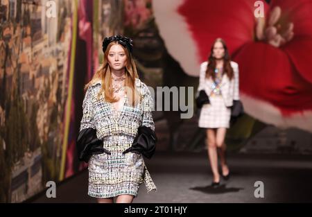 Paris, France. 3rd Oct, 2023. Models present creations by French fashion house Chanel as part of its Spring/Summer 2024 ready-to-wear collections during the Paris Fashion Week in Paris, France, on Oct. 3, 2023. Credit: Gao Jing/Xinhua/Alamy Live News Stock Photo