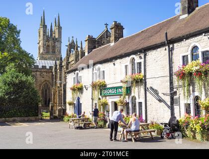 Tideswell The George Inn and St John the Baptist Church of England church in Tideswell Derbyshire Dales Derbyshire Derbyshire England UK GB Europe Stock Photo