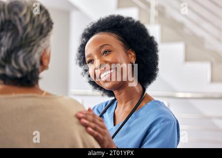 Black woman nurse, senior patient and help at retirement home with elderly care, support and counseling. People sitting together, healthcare and Stock Photo