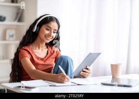 Happy young indian woman student have online training, home interior Stock Photo