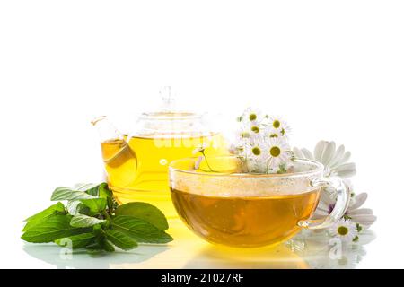 Chamomile flower tea in glass cup and teapot, isolated on white ...