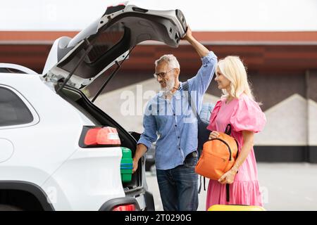 Active excited retired spouses traveling by car together Stock Photo