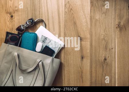 Travel Essentials Pack For Trip, Things Pack In Carry-On. Packing list for Airplane Tote. Female Carry-On luggage tote bag with laptop, notepad Stock Photo