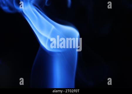 Blue smoke on a dark background, abstract pattern Stock Photo