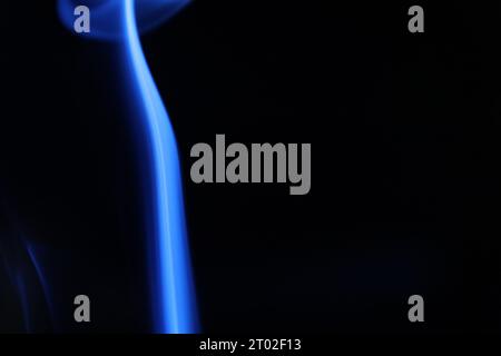 Blue line, blue smoke on a dark background, colourful abstract, blue fog, minimalism, line of light Stock Photo
