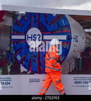 London, UK. 3rd October 2023. A worker walks past the HS2 construction site at Euston Station, as reports suggest that part of the High Speed 2 rail line, between Birmingham and Manchester, may be cut due to spiralling costs. The multi-billion pound project has been beset with problems and delays. Credit: Vuk Valcic/Alamy Live News Stock Photo