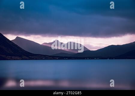 Impressive sundown over a Lofoten fjord. God's rays breaking through the clouds and create a spectacular lighting  situation. Stock Photo