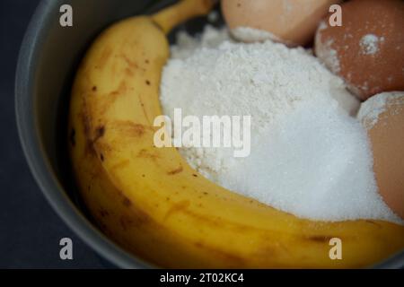 ingredients for a banana cake in a cake tin Stock Photo