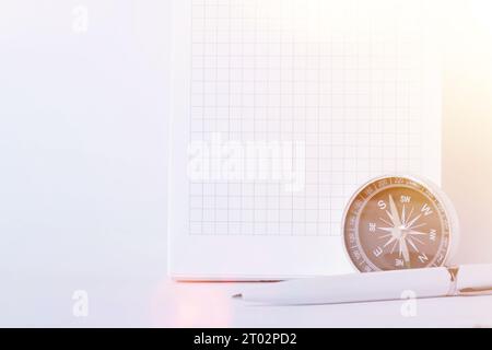 Traveler's notes. A clean notebook with a pen for writing a compass and a map . The concept of travel.. Stock Photo