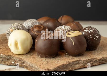 chocolate truffles on a flagstone in dark background Stock Photo