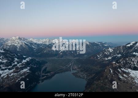 Great drone photo over the Swiss Alps at an epic sunrise with a pink horizon. Stock Photo