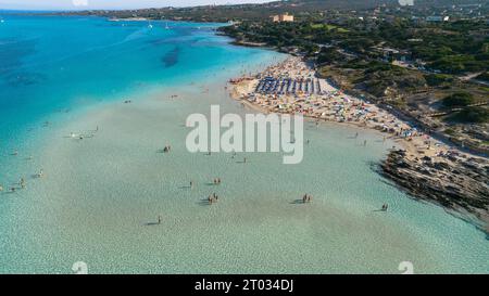 Aerial view of La Pelosa beach at sunny summer day. Stintino, Sardinia island, Italy. Drone view of sandy beach, playing people, clear blue sea. Stock Photo