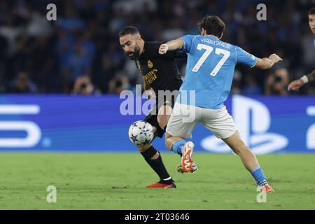Naples, Italy. 03rd Oct, 2023. Real Madrid's Spanish defender Daniel Carvajal challenges for the ball with SSC Napoliâ&#x80;&#x99;s forward Khvicha Kvaratskhelia during the Uefa champions league match between SSC Napoli vs Real Madrid at the Diego Armando Maradona Stadium in Naples, southern Italy, on October 03, 2023. Credit: Independent Photo Agency/Alamy Live News Stock Photo