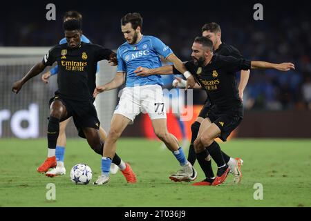 Naples, Italy. 03rd Oct, 2023. SSC Napoliâ&#x80;&#x99;s forward Khvicha Kvaratskhelia challenges for the ball with Real Madrid's French midfielder Aurelien Tchouameni (L) and Real Madrid's Spanish defender Daniel Carvajal (R) during the Uefa champions league match between SSC Napoli vs Real Madrid at the Diego Armando Maradona Stadium in Naples, southern Italy, on October 03, 2023. Credit: Independent Photo Agency/Alamy Live News Stock Photo