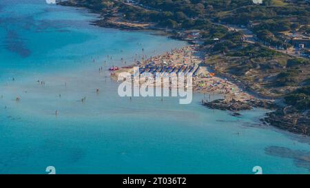 Aerial view of La Pelosa beach at sunny summer day. Stintino, Sardinia island, Italy. Drone view of sandy beach, playing people, clear blue sea. Stock Photo