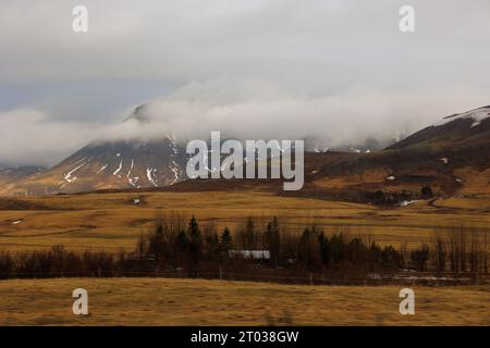 Car drive on reykjavik street capital to see icelandic countryside scenery during roadtrip around fields. Spectacular nordic adventure on roads in Iceland, scandinavian hills and mountains. Stock Photo