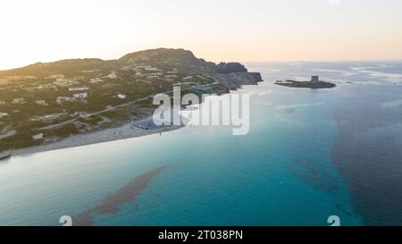 Aerial view of La Pelosa beach at sunny summer day. Stintino, Sardinia island, Italy. Drone view of sandy beach, playing people, clear blue sea. Stock Photo