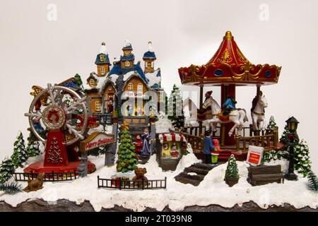 Christmas village miniature with carousel, toy shop and ferris wheel Stock Photo
