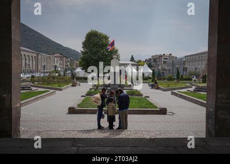 Refugees of Karabakh are seen standing in the main square next to the flag of Republic of Nagorno-Karabakh in Goris. Armenia reported on the 3rd October that around 100,625 refugees have arrived from Nagorno-Karabakh while 91,924 of them have been already registered by Armenian officials after Azerbaijan took control of the southern mountainous region. Stock Photo