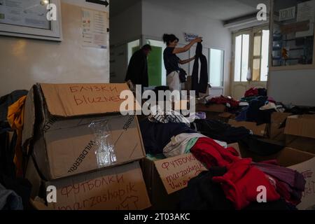 A refugee picks clothes at a humanitarian aid distribution point in Goris. Armenia reported on the 3rd October that around 100,625 refugees have arrived from Nagorno-Karabakh while 91,924 of them have been already registered by Armenian officials after Azerbaijan took control of the southern mountainous region. Stock Photo