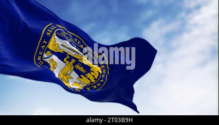 Nebraska state flag waving in the wind on a clear day. Blue with the state seal in the center. 3d illustration render. Fluttering fabric. Selective fo Stock Photo