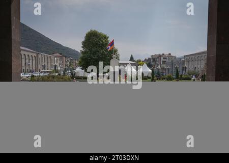Goris, Armenia. 2nd Oct, 2023. Refugees of Karabakh are seen standing in the main square next to the flag of Republic of Nagorno-Karabakh in Goris. Armenia reported on the 3rd October that around 100,625 refugees have arrived from Nagorno-Karabakh while 91,924 of them have been already registered by Armenian officials after Azerbaijan took control of the southern mountainous region. (Credit Image: © Ashley Chan/SOPA Images via ZUMA Press Wire) EDITORIAL USAGE ONLY! Not for Commercial USAGE! Stock Photo