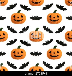 Seamless pattern with Halloween pumpkin and bats on white background. Jack's head background. Toy Halloween pumpkin made of wool. Stock Photo