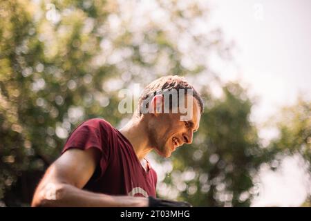 Portrait of tired man farmer standing in the garden during summer heat Stock Photo