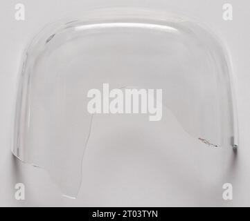Sharp broken transparent bowl piece isolated  on studio background Stock Photo