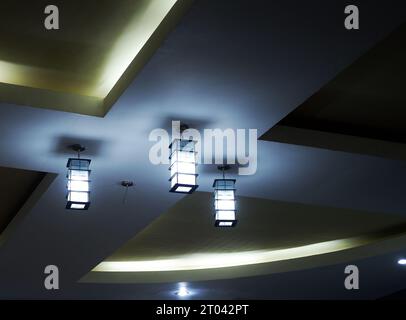 Three box-shaped lights are installed above the ceiling of the room Stock Photo
