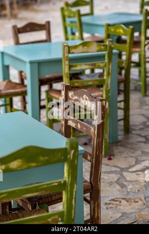 shabby chic tables and chairs painted in blue and green colours at a greek taverna on the island of zante or zakynthos. Stock Photo