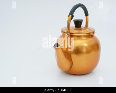 vintage gold toned aluminum tea kettle isolated on white background Stock Photo