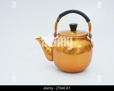 vintage gold toned aluminum tea kettle isolated on white background Stock Photo